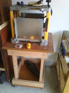 The power planer stand with some recycled wainscotting as platforms.  2" castors.  Integrated with the height of the bandsaw/router table.